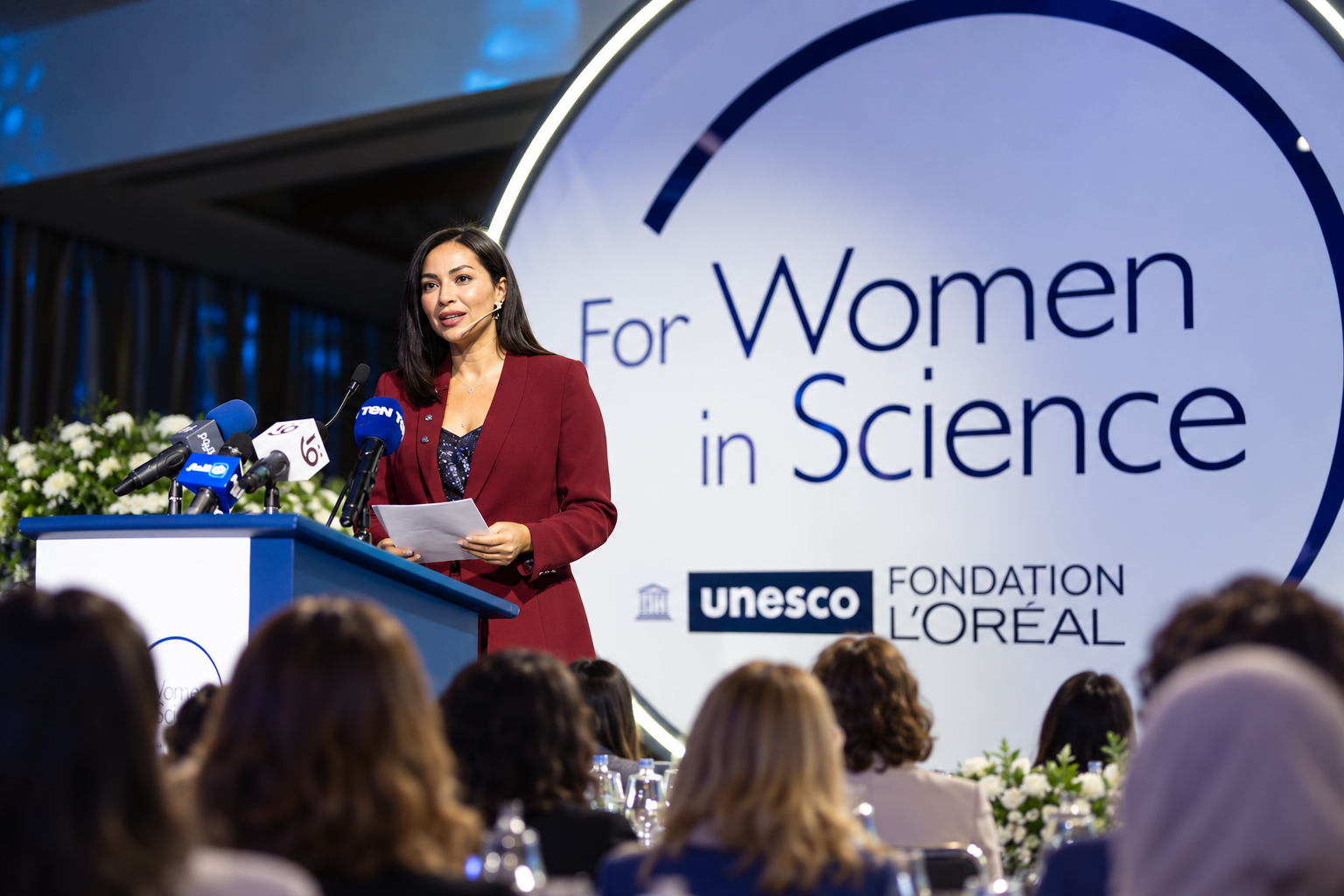 Rana Arafa moderating a leadership panel on stage at a major summit